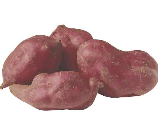 A 1kg bag of red kumara with vibrant reddish-purple skin, optionally include a few loose and one cut in half to showcase the orange flesh.