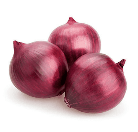 A 1kg bag of unpeeled red onions showing their vibrant purple-red skin and a few loose onions with some natural dried outer layers still attached.